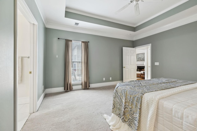bedroom featuring light colored carpet, ornamental molding, baseboards, a raised ceiling, and ceiling fan