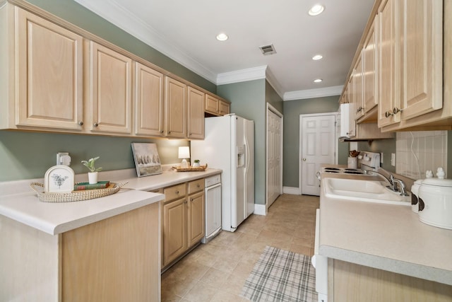 kitchen featuring crown molding, a sink, light brown cabinets, white appliances, and visible vents