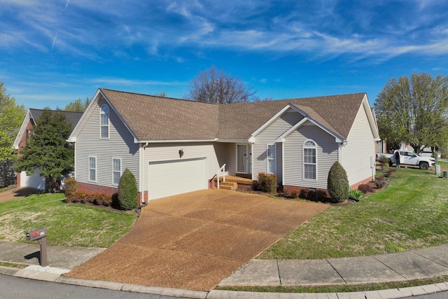ranch-style house featuring roof with shingles, a front yard, a garage, and concrete driveway
