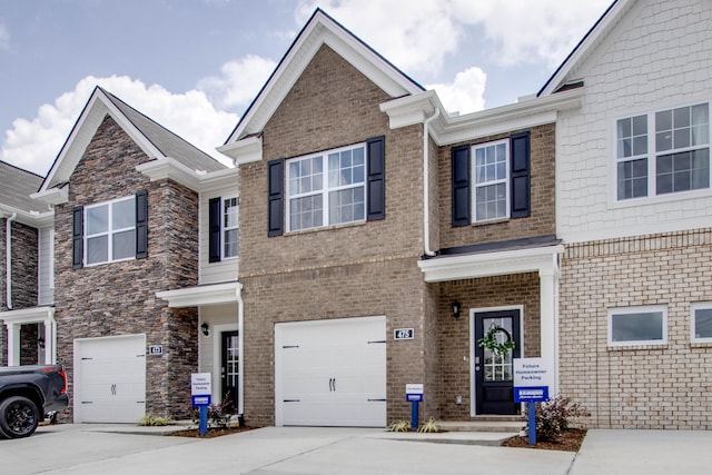 view of front of home featuring brick siding, driveway, and a garage