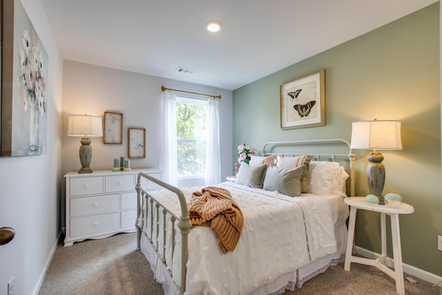 bedroom featuring visible vents, baseboards, and carpet