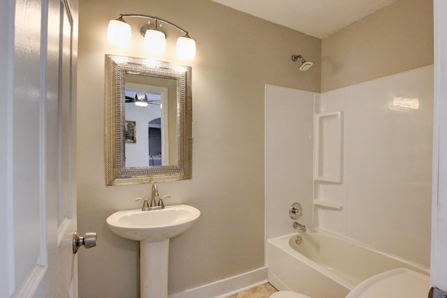 full bathroom with shower / washtub combination, toilet, and baseboards