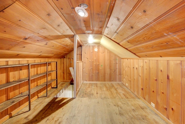 bonus room with wooden walls, a sauna, hardwood / wood-style flooring, vaulted ceiling, and wood ceiling