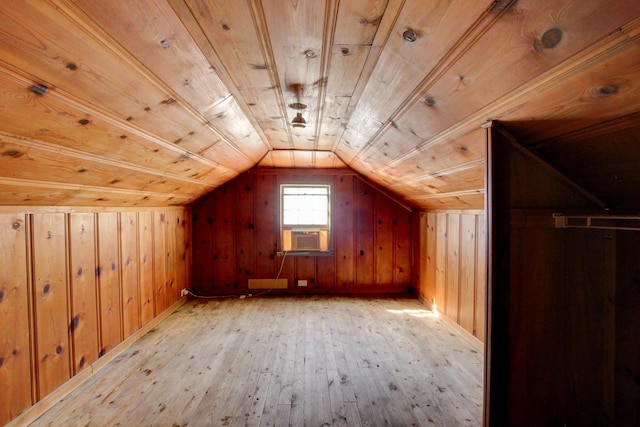 additional living space with light wood finished floors, wooden walls, wooden ceiling, and vaulted ceiling