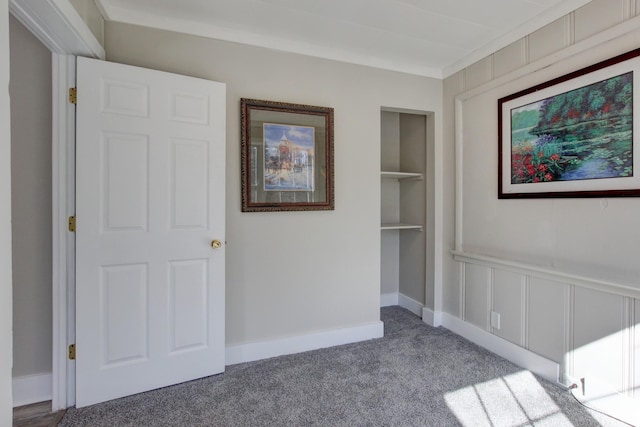 interior space with carpet flooring, a decorative wall, and built in features
