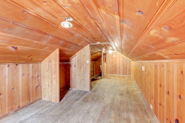 additional living space featuring hardwood / wood-style flooring, wooden ceiling, wood walls, and vaulted ceiling