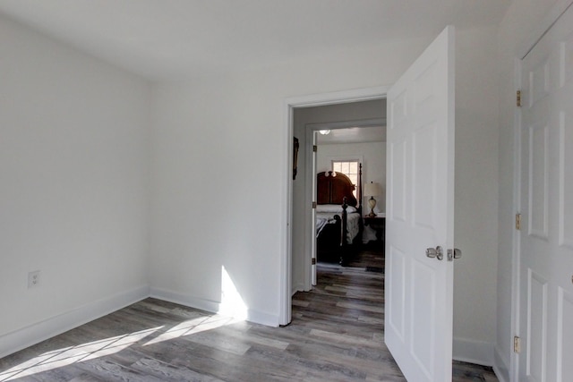 unfurnished room featuring baseboards and light wood-type flooring
