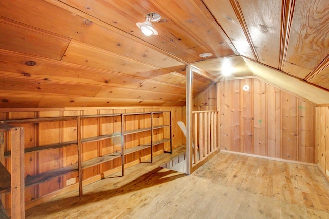 bonus room with vaulted ceiling, wood walls, wooden ceiling, and hardwood / wood-style flooring