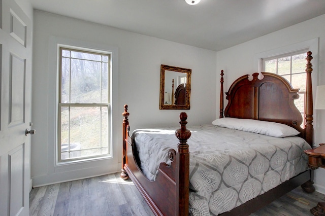 bedroom with wood finished floors and baseboards