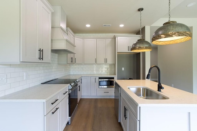 kitchen with a sink, dishwasher, recessed lighting, visible vents, and range with electric stovetop