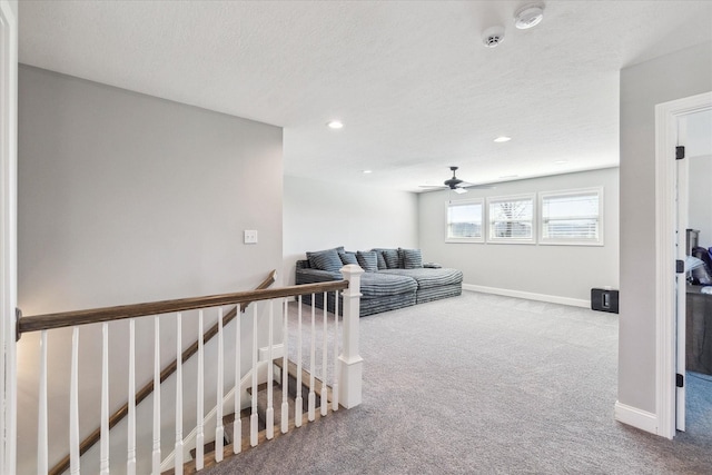 carpeted living room featuring recessed lighting, baseboards, a textured ceiling, and a ceiling fan