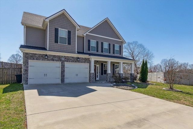 craftsman inspired home with a garage, stone siding, concrete driveway, and fence