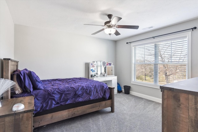 carpeted bedroom with visible vents, ceiling fan, and baseboards