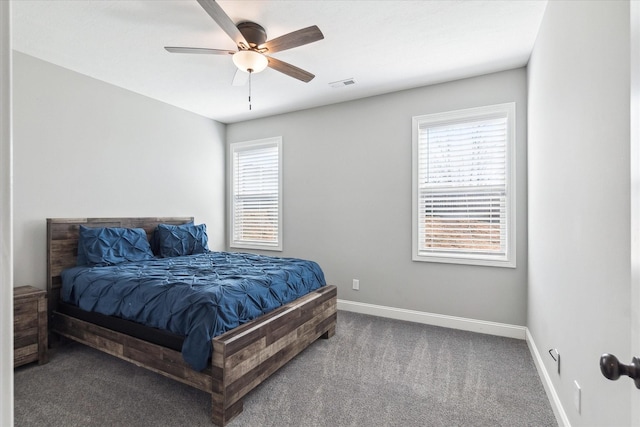 bedroom featuring visible vents, multiple windows, baseboards, and carpet flooring