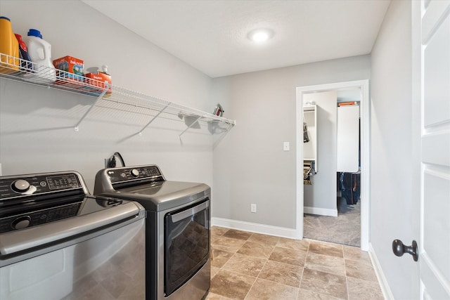 laundry room featuring laundry area, baseboards, and washing machine and clothes dryer