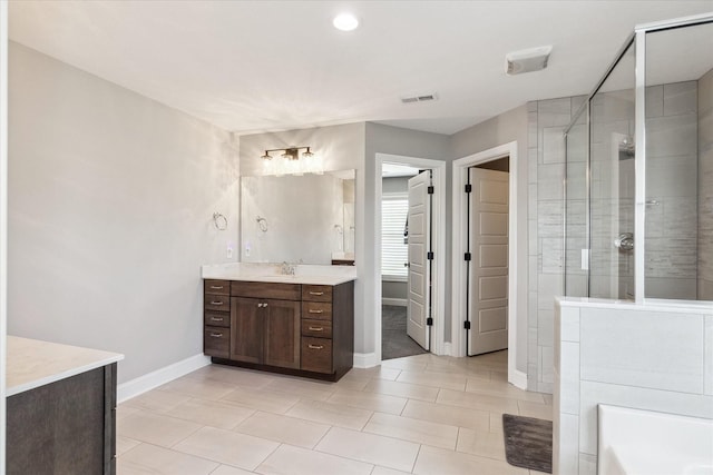 bathroom with vanity, baseboards, visible vents, tile patterned flooring, and a shower stall