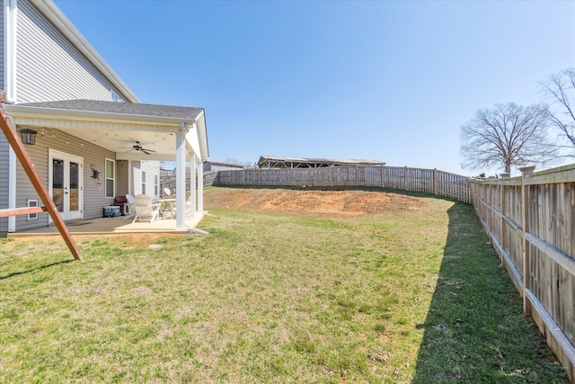 view of yard featuring a fenced backyard, french doors, ceiling fan, and a patio
