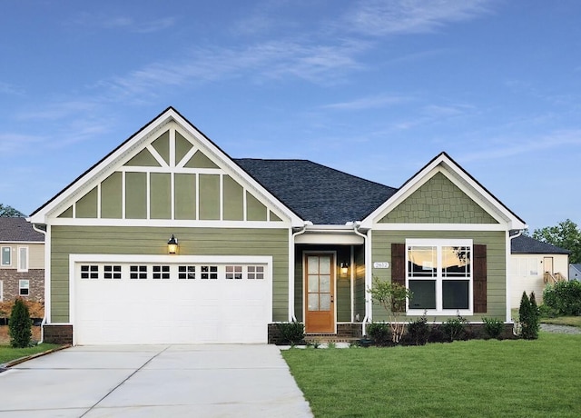 craftsman inspired home with concrete driveway, an attached garage, and a front lawn