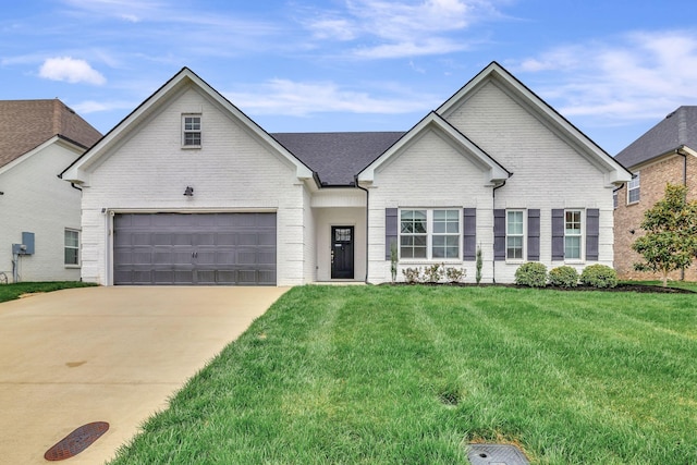 view of front of property featuring a front yard, brick siding, and concrete driveway