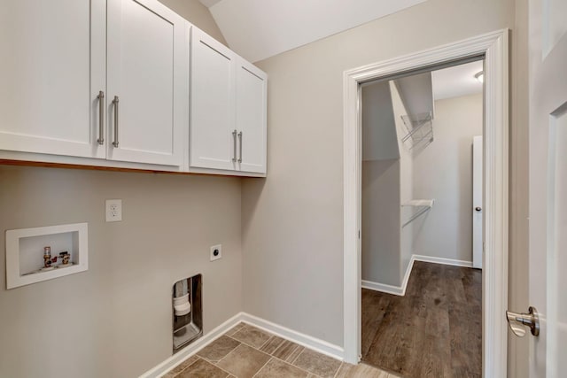 clothes washing area featuring baseboards, washer hookup, hookup for an electric dryer, and cabinet space