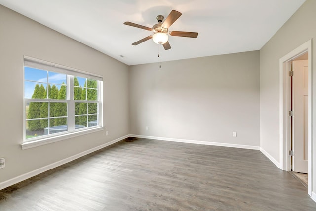 unfurnished room featuring a ceiling fan, baseboards, and wood finished floors