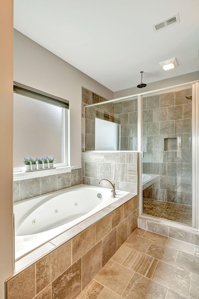 bathroom featuring visible vents, a stall shower, and a whirlpool tub
