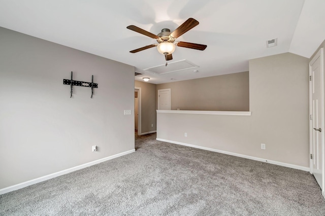 carpeted empty room featuring visible vents, baseboards, ceiling fan, attic access, and lofted ceiling