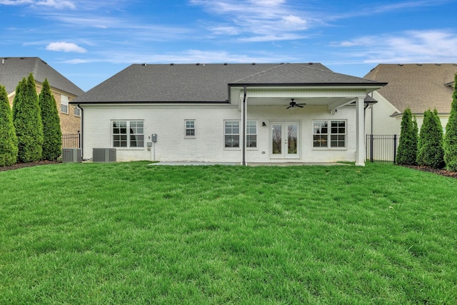 back of house with a fenced backyard, ceiling fan, brick siding, and a yard