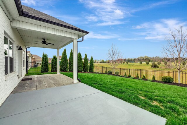 view of patio with a fenced backyard and ceiling fan