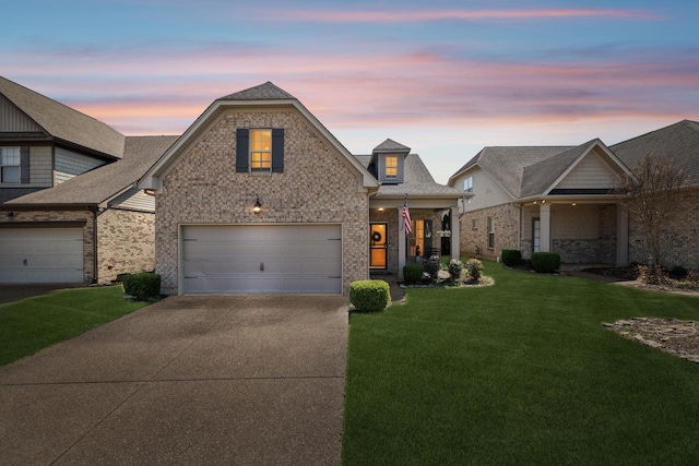 view of front facade featuring concrete driveway, a garage, brick siding, a shingled roof, and a lawn