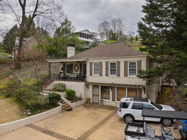 1608 Riverview Rd, Chattanooga, TN 37405 - view of front of home with a shingled roof, concrete driveway, stairway, and a chimney