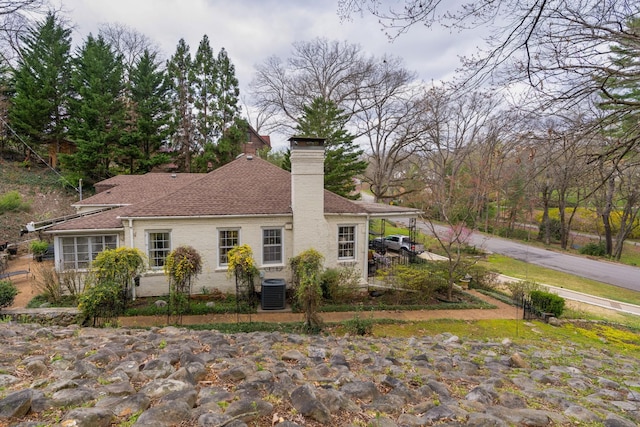 1608 Riverview Rd, Chattanooga, TN 37405 - rear view of house with central AC, a chimney, and a shingled roof