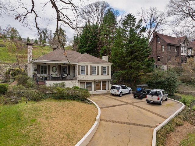 1608 Riverview Rd, Chattanooga, TN 37405 - view of front facade featuring driveway, a porch, a front yard, ceiling fan, and a chimney