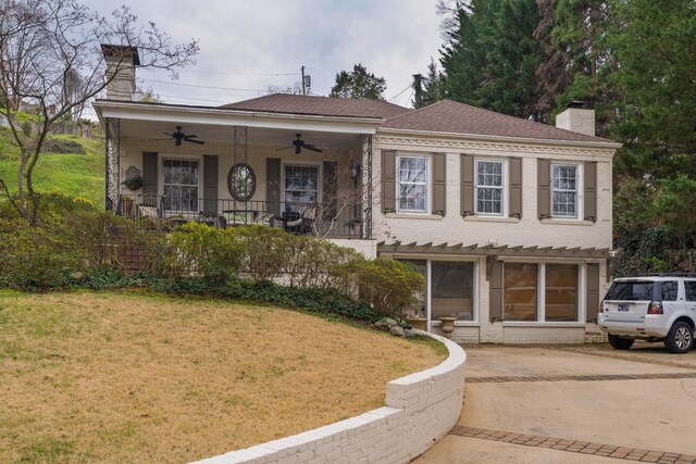 1608 Riverview Rd, Chattanooga, TN 37405 - view of front of property featuring covered porch, a chimney, a ceiling fan, and a front yard