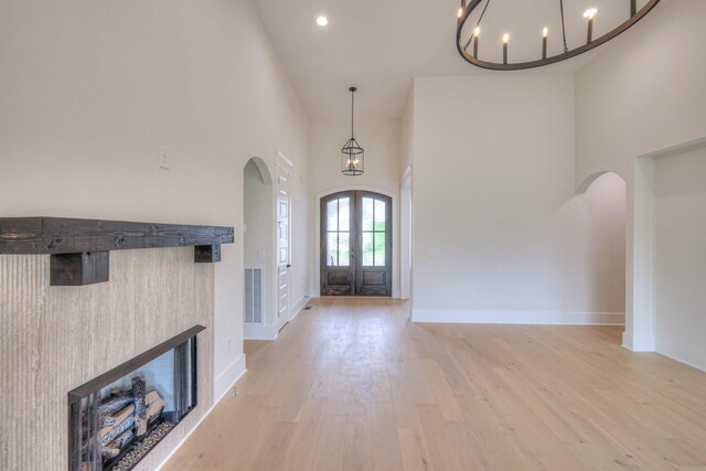 1251 Payton Ln, Gallatin, TN 37066 - entrance foyer with arched walkways, a towering ceiling, light wood-type flooring, baseboards, and french doors