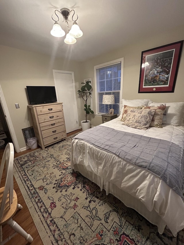 143 39th Ave N, Nashville, TN 37209 - bedroom with baseboards, a notable chandelier, and wood finished floors