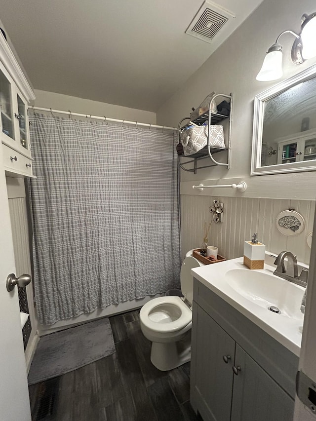 143 39th Ave N, Nashville, TN 37209 - bathroom with vanity, wood finished floors, a wainscoted wall, visible vents, and toilet