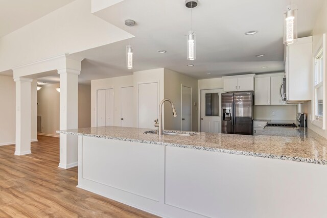 1106 Roseland Dr, Columbia, TN 38401 - kitchen featuring a sink, light stone countertops, appliances with stainless steel finishes, white cabinets, and ornate columns