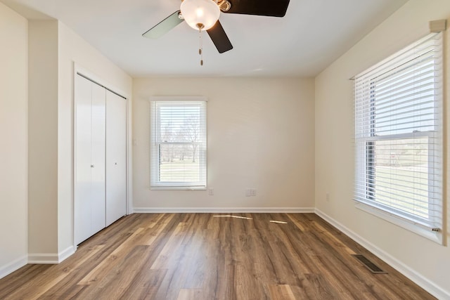 1106 Roseland Dr, Columbia, TN 38401 - unfurnished bedroom with a closet, visible vents, baseboards, ceiling fan, and wood finished floors