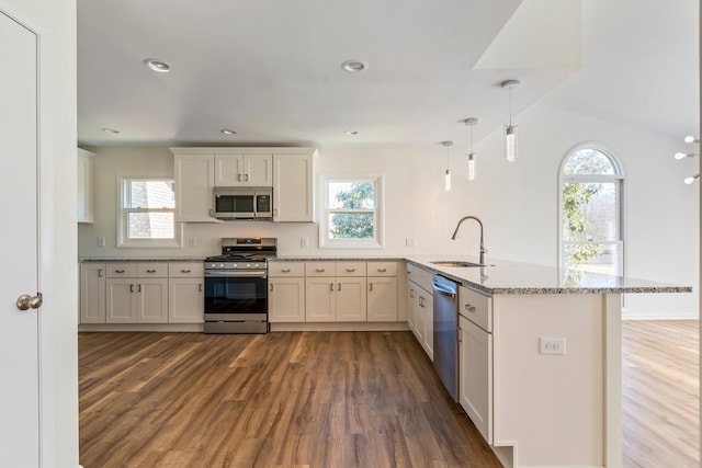 1106 Roseland Dr, Columbia, TN 38401 - kitchen with a sink, light stone countertops, wood finished floors, a peninsula, and stainless steel appliances