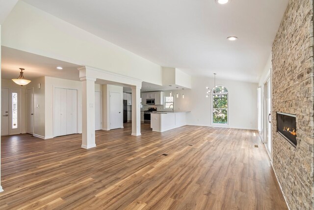 1106 Roseland Dr, Columbia, TN 38401 - unfurnished living room featuring a sink, baseboards, a fireplace, and wood finished floors