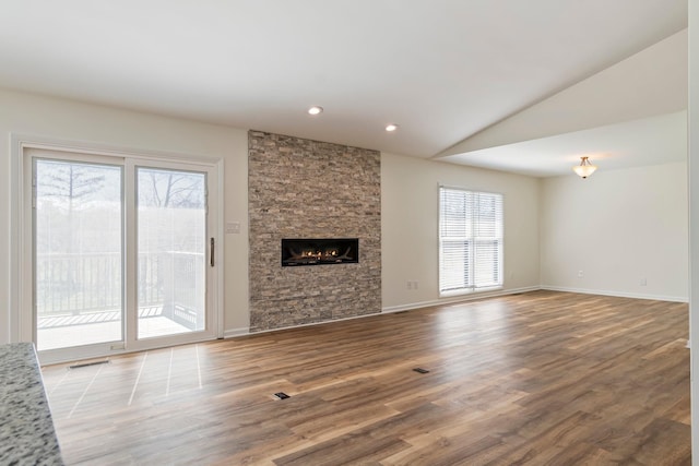 1106 Roseland Dr, Columbia, TN 38401 - unfurnished living room with vaulted ceiling, recessed lighting, visible vents, a fireplace, and wood finished floors