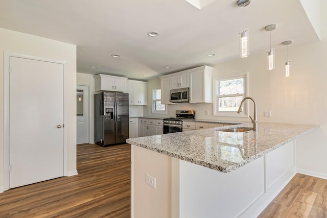 1106 Roseland Dr, Columbia, TN 38401 - kitchen with a sink, wood finished floors, a peninsula, and appliances with stainless steel finishes