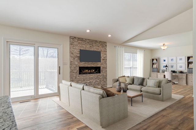 1106 Roseland Dr, Columbia, TN 38401 - living area with a fireplace, visible vents, vaulted ceiling, and wood finished floors