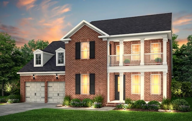 view of front of home with brick siding, driveway, an attached garage, and a balcony