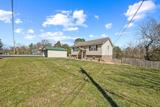 view of front facade featuring aphalt driveway, fence, and a front lawn