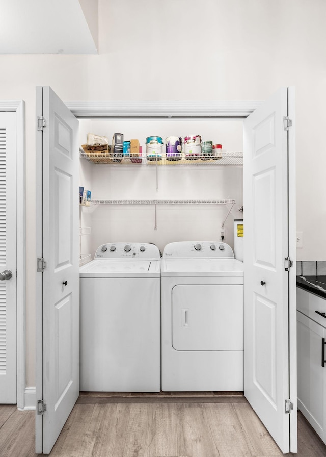 laundry room featuring light wood-style floors, independent washer and dryer, and laundry area