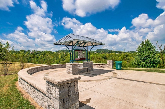 view of patio / terrace with a forest view
