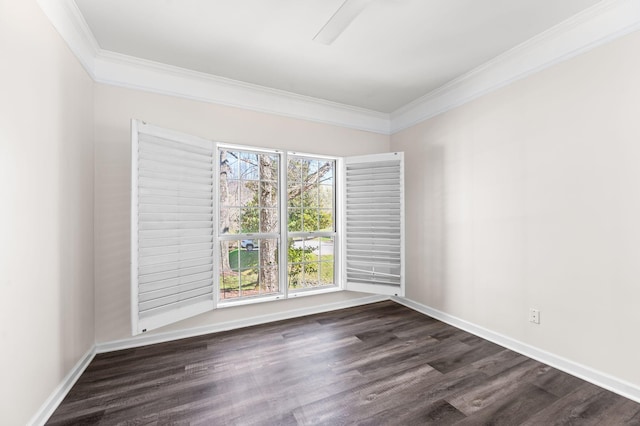 unfurnished room featuring ornamental molding, baseboards, and wood finished floors