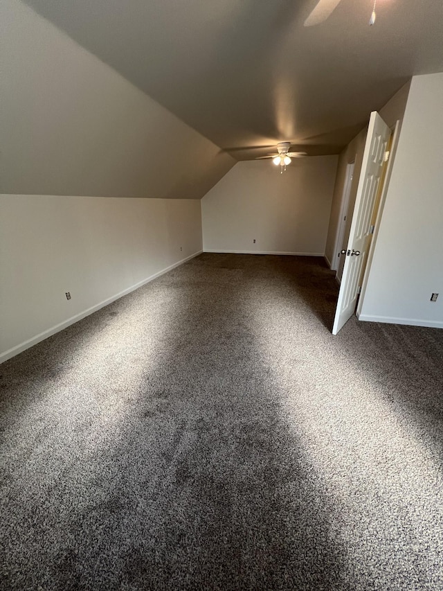 additional living space with baseboards, carpet, vaulted ceiling, and a ceiling fan